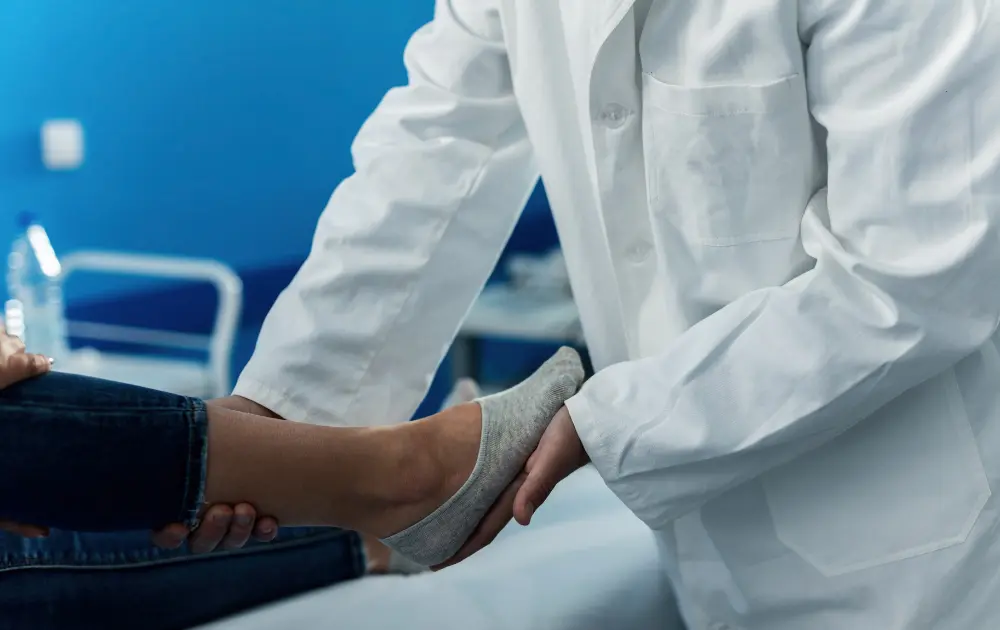 Doctor examining a patient's foot for plantar fasciitis
